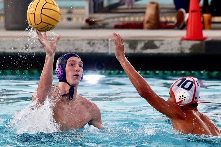 Lemoore's Case Meyer passes the ball over the outstretched hand of Atascadero's Rylen Miller.